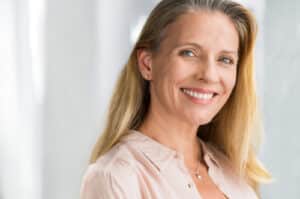 woman smiling with all on 4 dental implants in citrus heights, ca