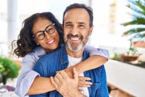Middle,Age,Hispanic,Couple,Smiling,Confident,Hugging,Each,Other,Sitting