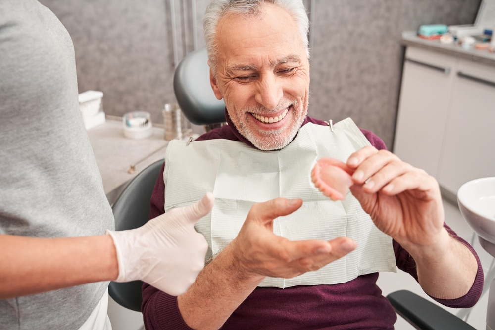 My,New,Teeth.,Cropped,View,Of,The,Dentist,Showing,To